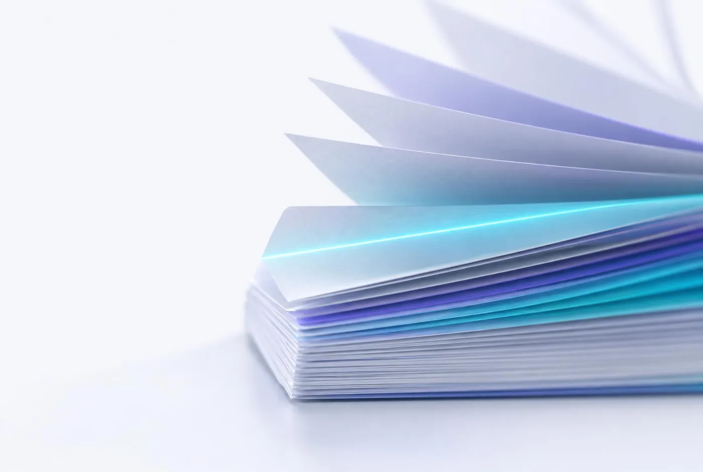 A stack of pages fanned open with light along the edges